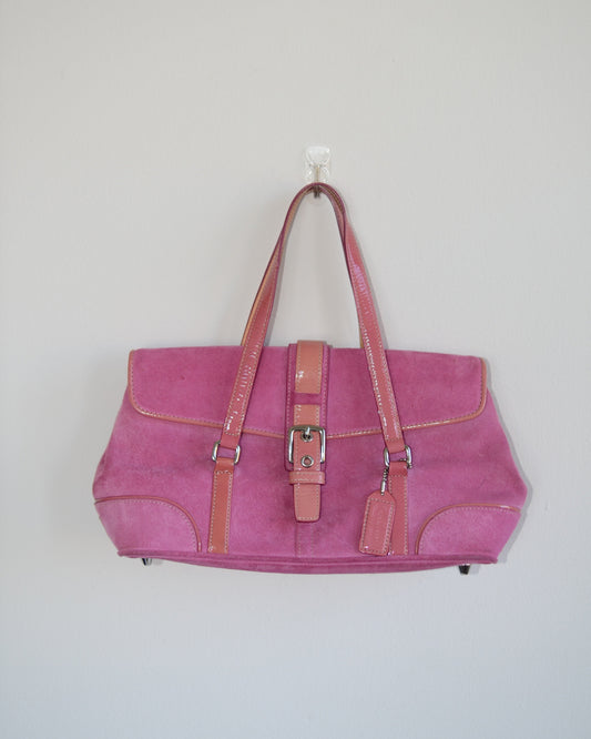 Pink vintage coach handbag with brown accents on a light gray background
