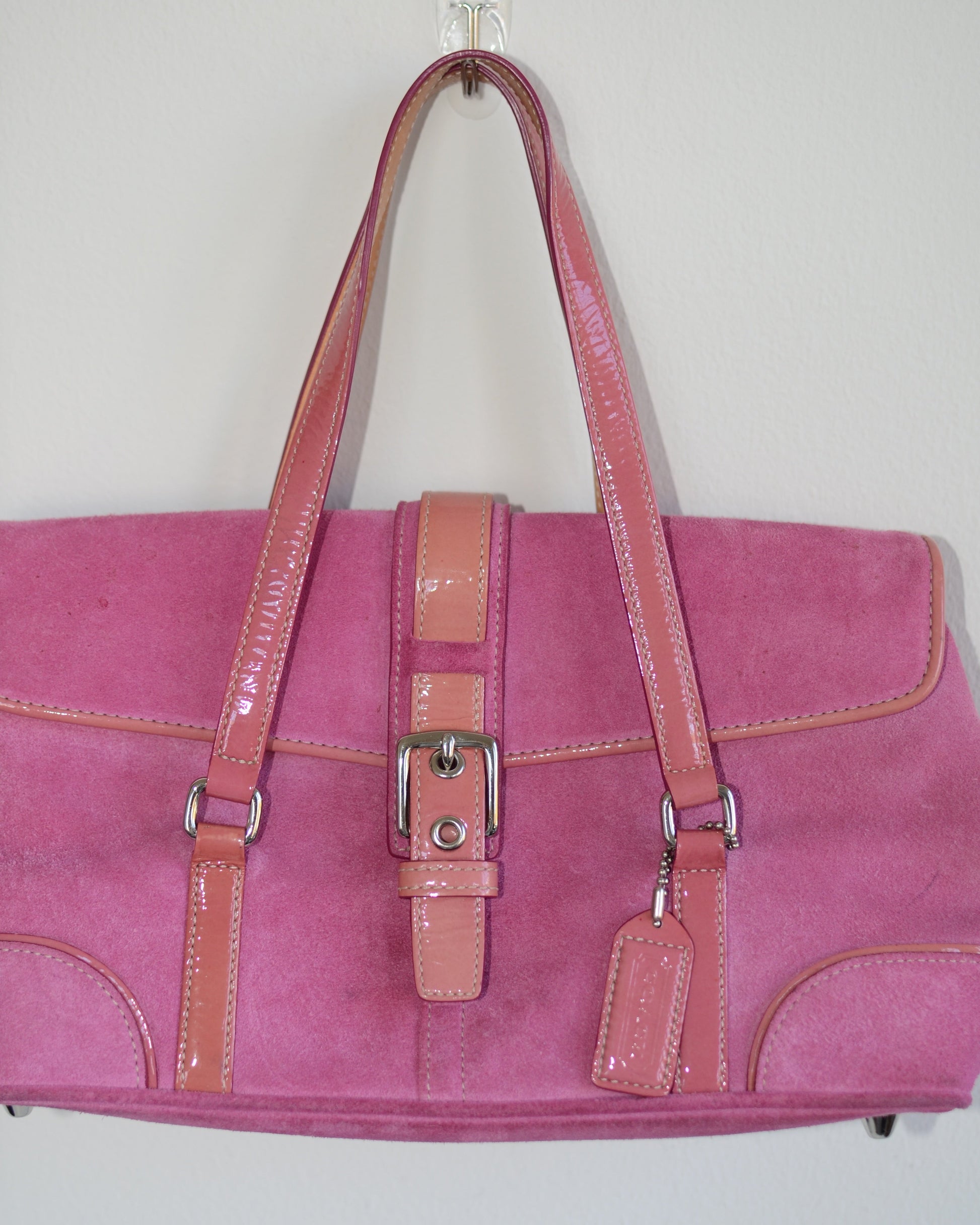 Pink vintage coach bag handbag with coral accents on a white background