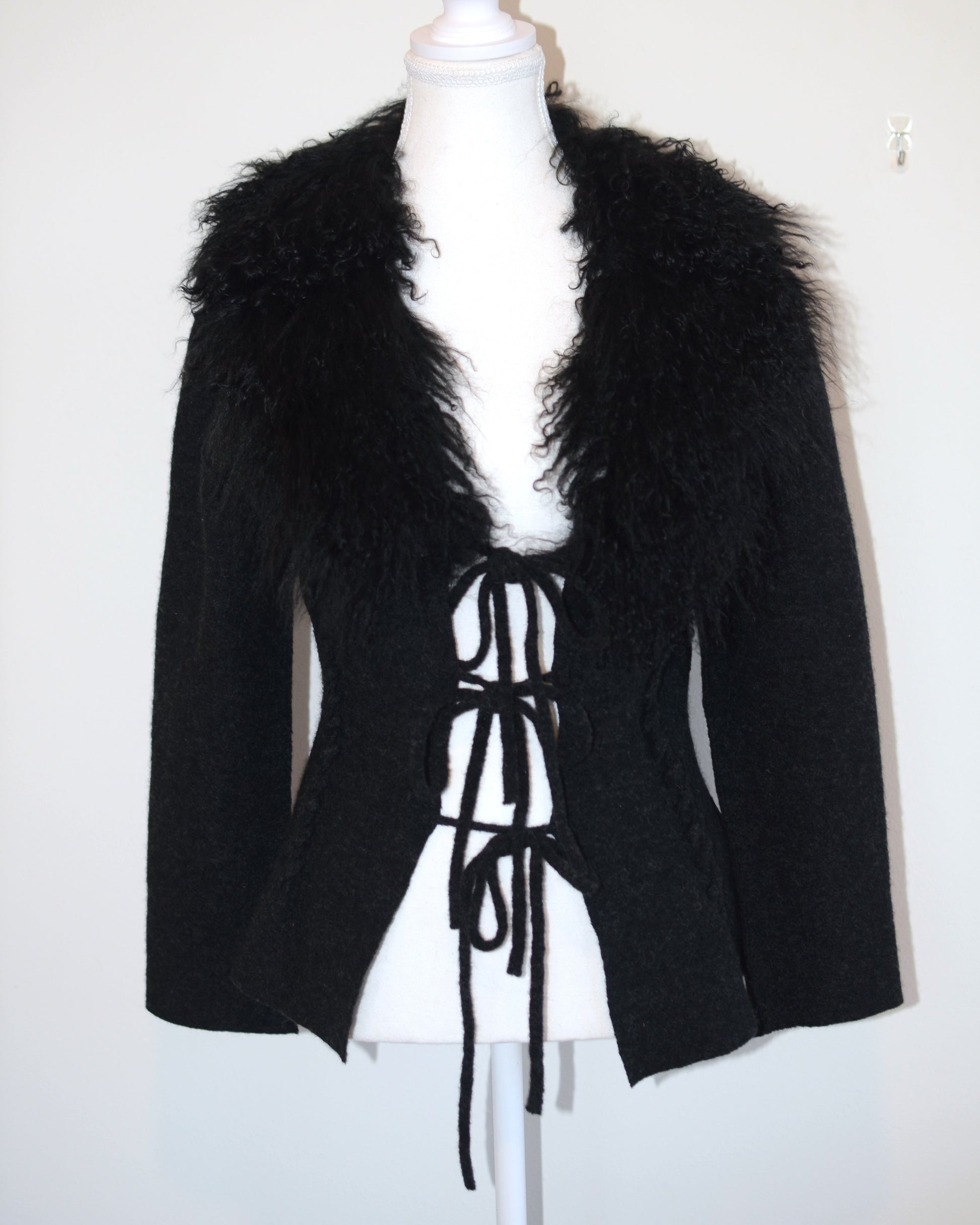 Black Roberto Cavalli jacket with faux fur  trim on a mannequin against a white background