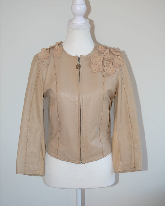 Roberto Cavalli Beige leather jacket with floral embellishments on a mannequin against a white background